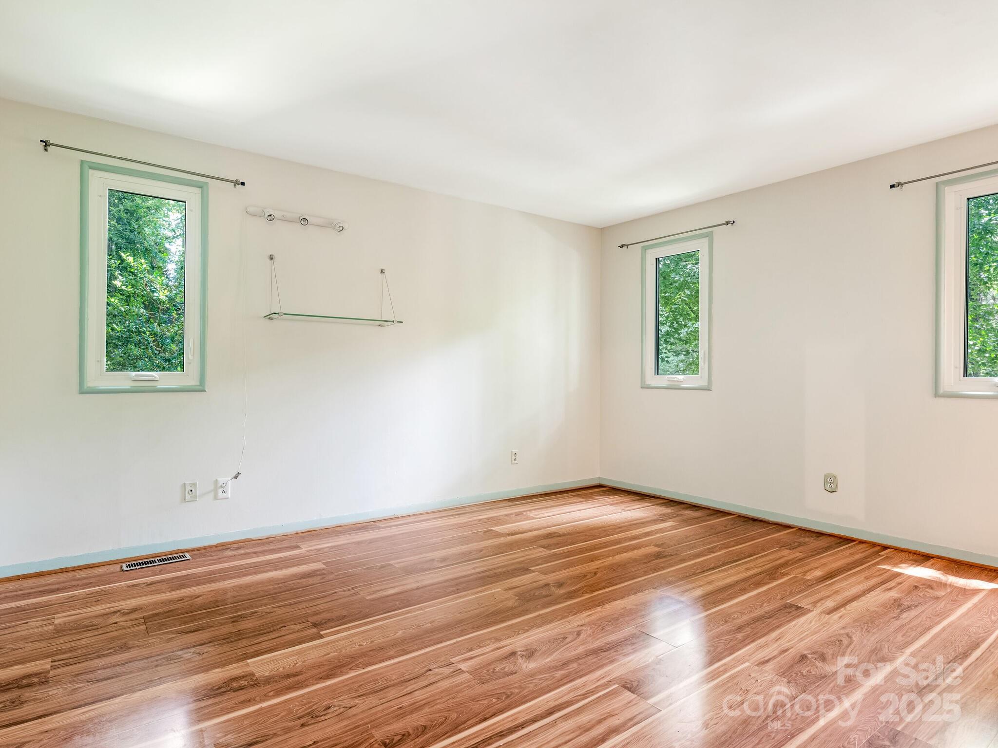 3310 Windbluff Drive Charlotte, NC 28277 - Photo 16 of 45 a view of empty room with wooden floor and fan