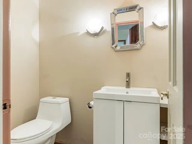 a bathroom with a sink a mirror and toilet