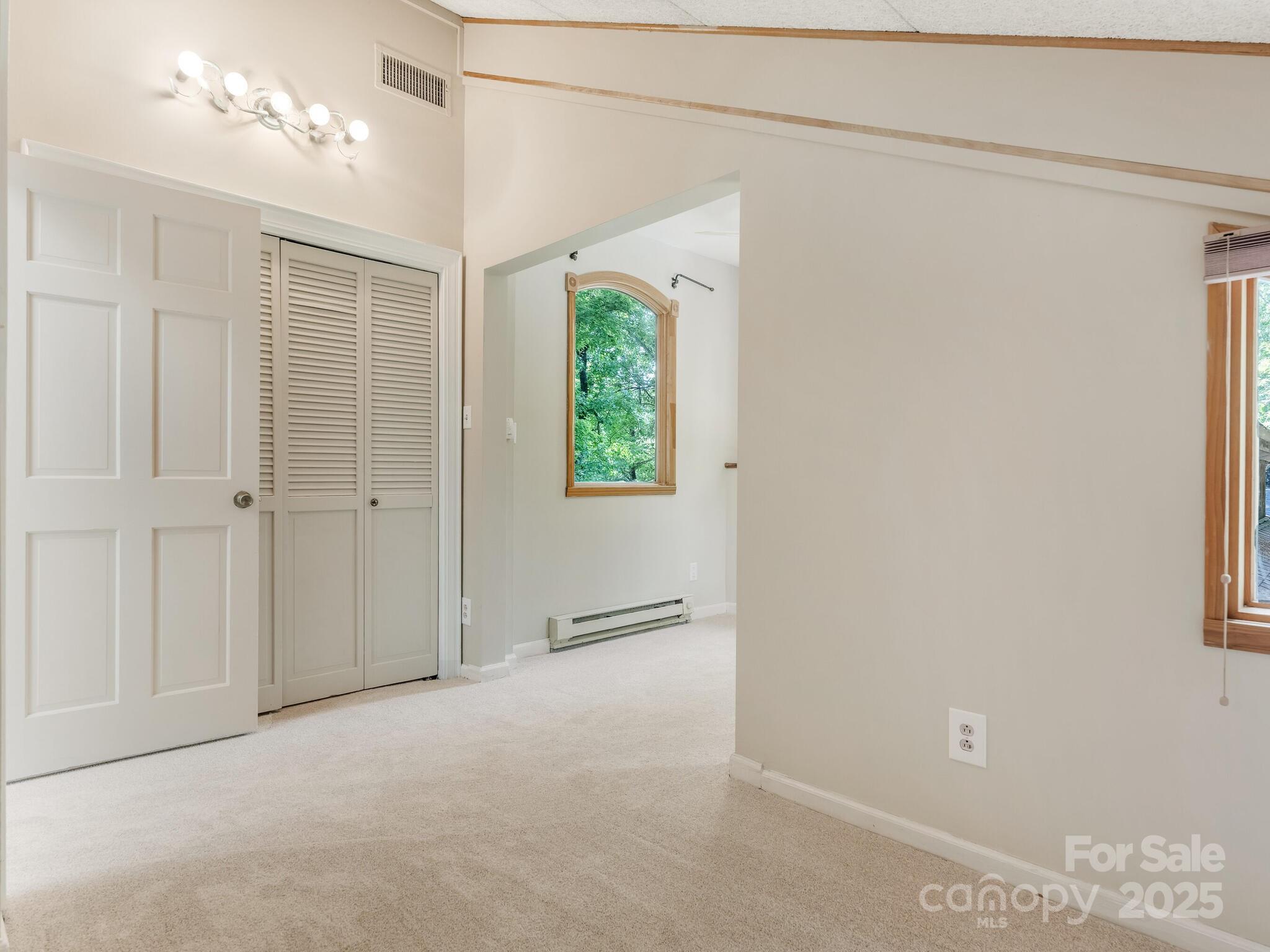 3310 Windbluff Drive Charlotte, NC 28277 - Photo 22 of 45 an empty room with a windows and a ceiling fan