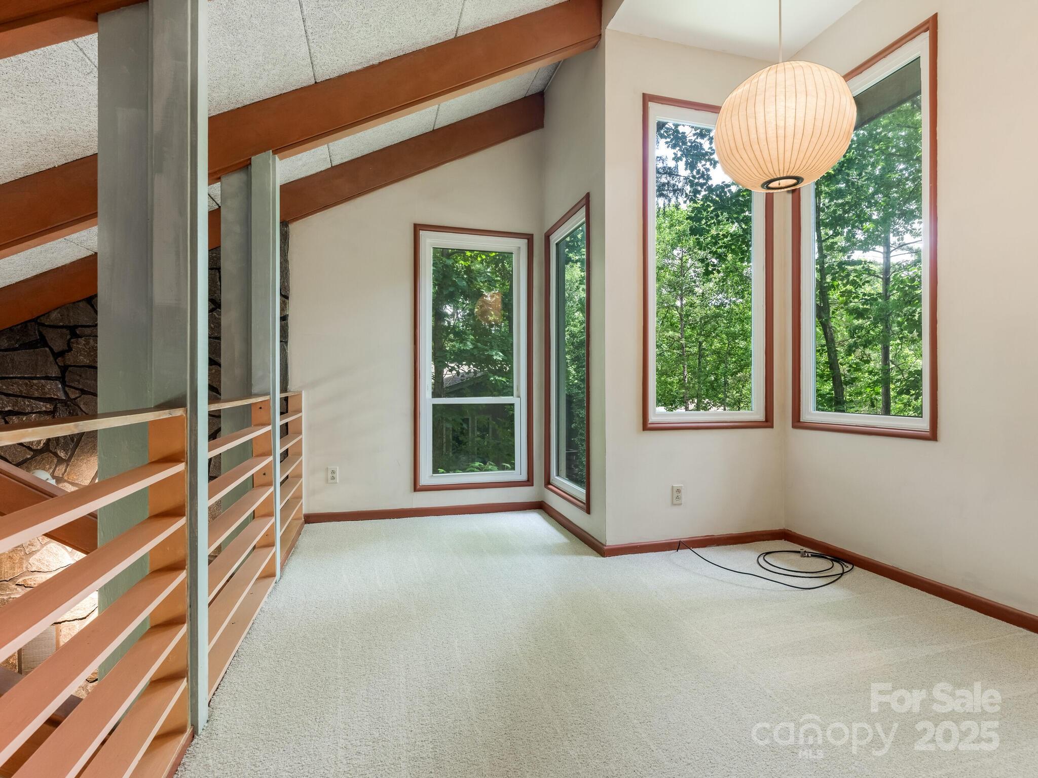 3310 Windbluff Drive Charlotte, NC 28277 - Photo 25 of 45 a view of an empty room with a window and wooden floor