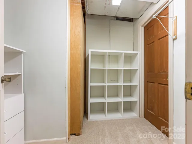 a view of closet area with empty racks