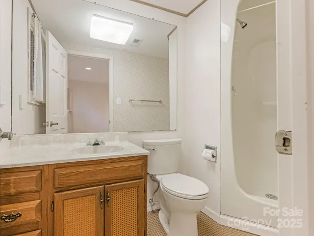 a bathroom with a sink toilet and shower