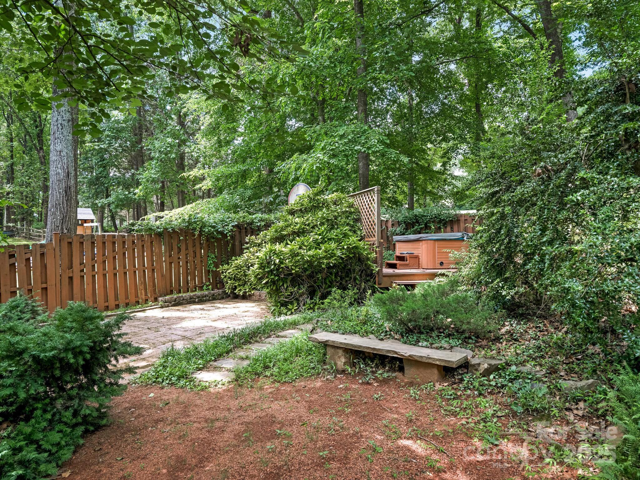 3310 Windbluff Drive Charlotte, NC 28277 - Photo 39 of 45 a view of a backyard with a bench and trees