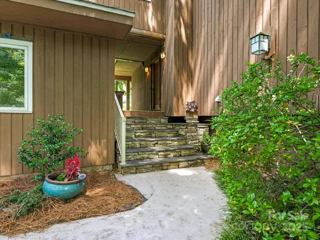 a view of a entryway of the house with potted plants