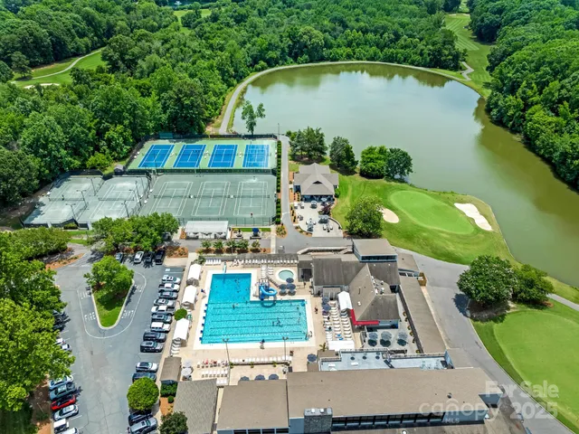 an aerial view of a house with outdoor space and lake view