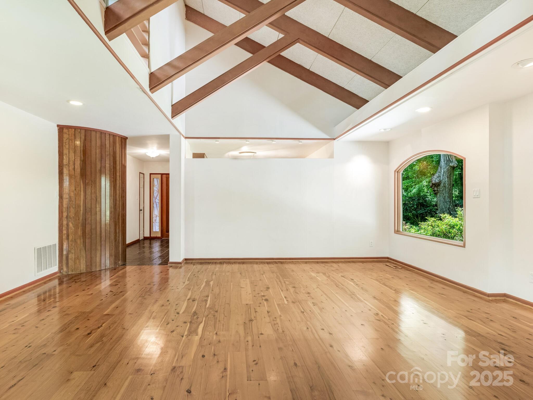 3310 Windbluff Drive Charlotte, NC 28277 - Photo 10 of 45 a view of an empty room with wooden floor and a window