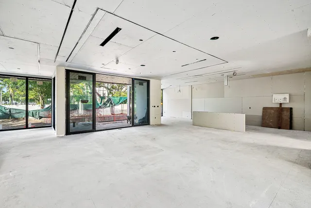an aerial view of a residential houses with outdoor space and street view