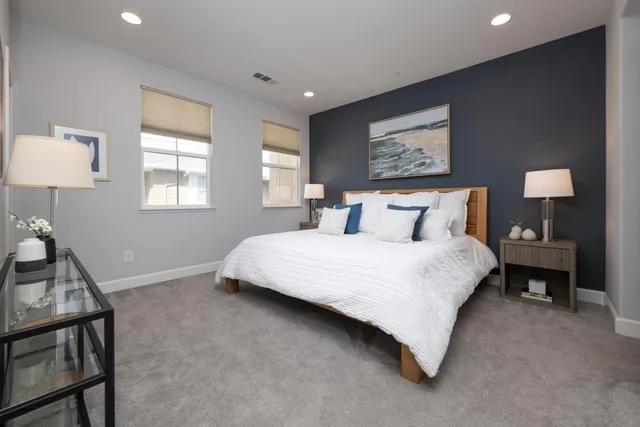 a bedroom with a bed and a lamp