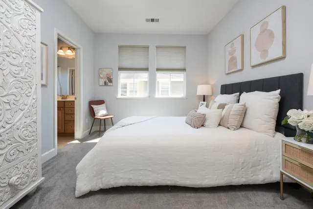 a bathroom with a sink a toilet a mirror and shower