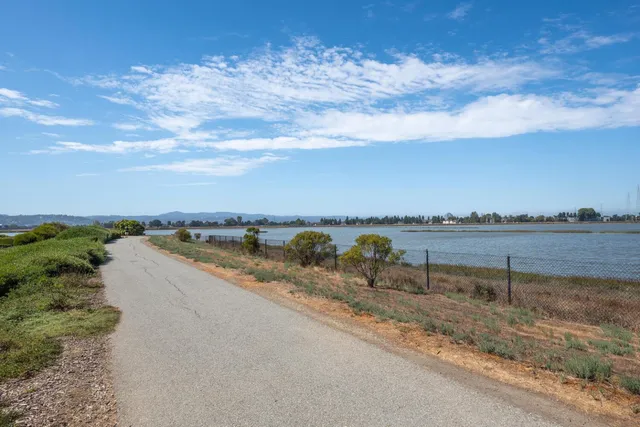 an aerial view of a house with a swimming pool and outdoor seating