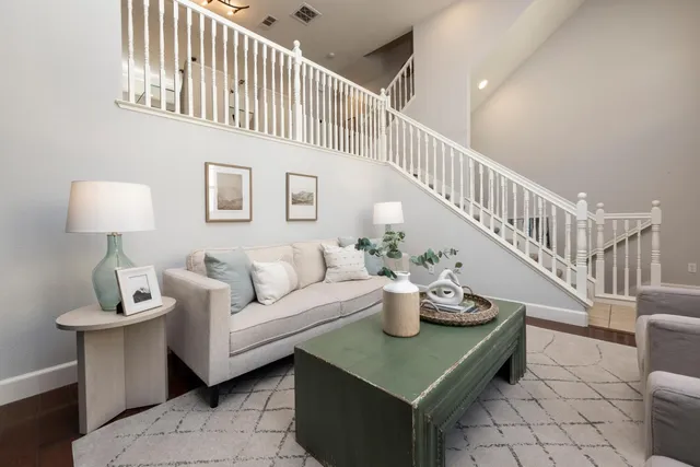 a living room with furniture and a floor to ceiling window