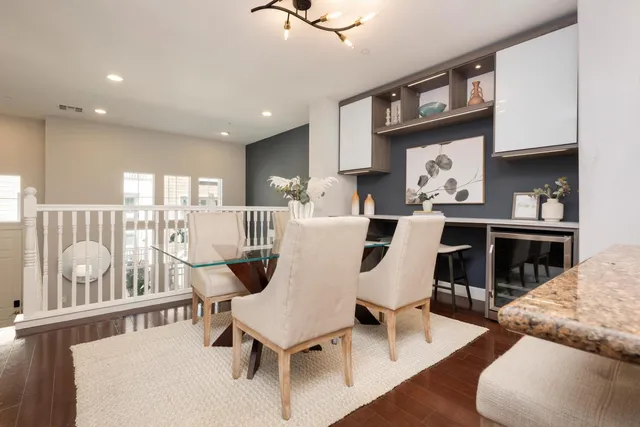 a dinning table with chairs and wooden floor
