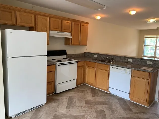 a white refrigerator freezer sitting inside of a kitchen