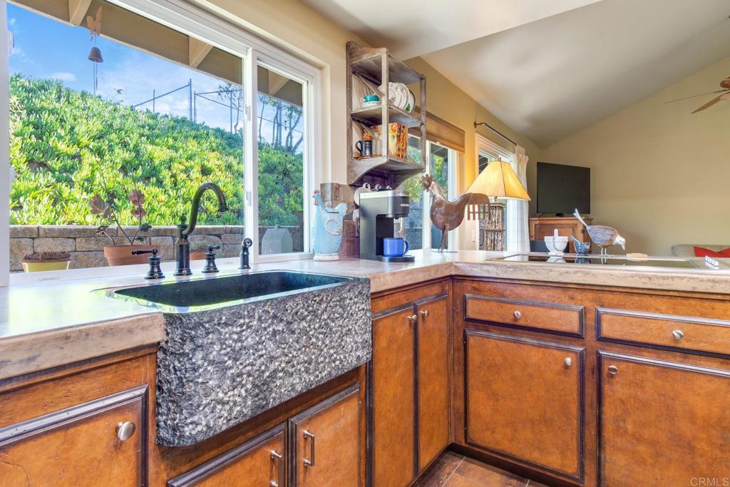 1106 Big Oak Ranch Road Fallbrook, CA 92028 - Photo 19 of 53 a kitchen with stainless steel appliances granite countertop a sink and a large window
