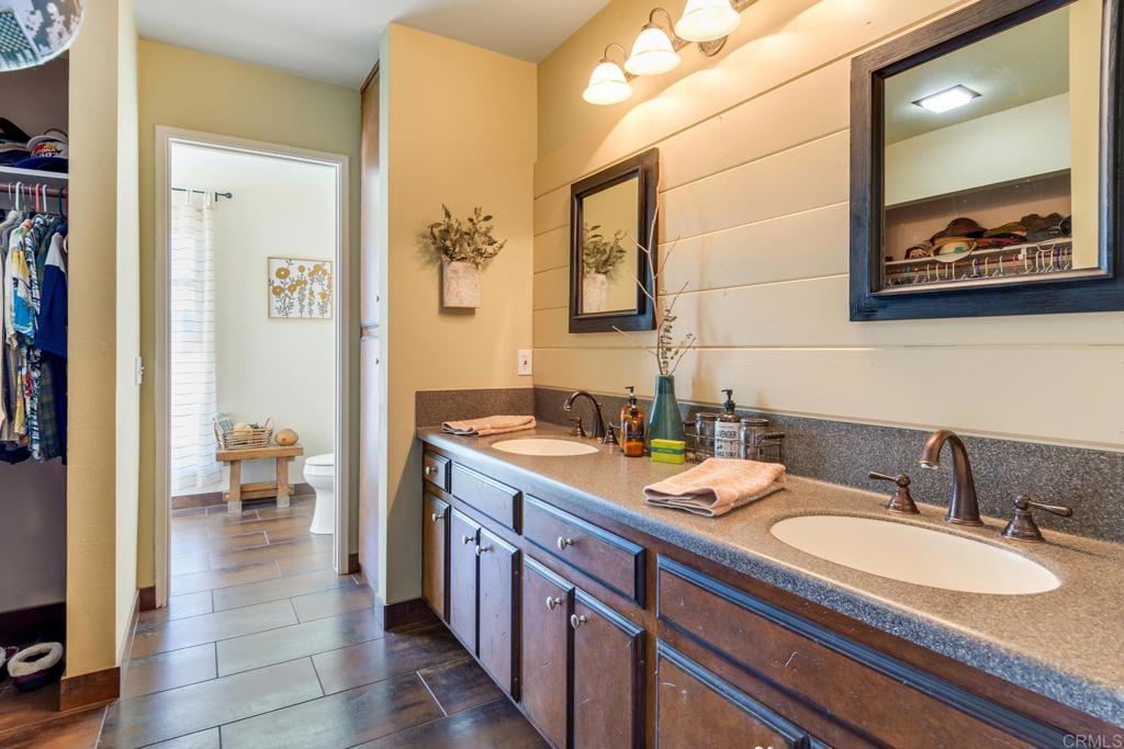 1106 Big Oak Ranch Road Fallbrook, CA 92028 - Photo 25 of 53 a bathroom with a granite countertop sink and a mirror