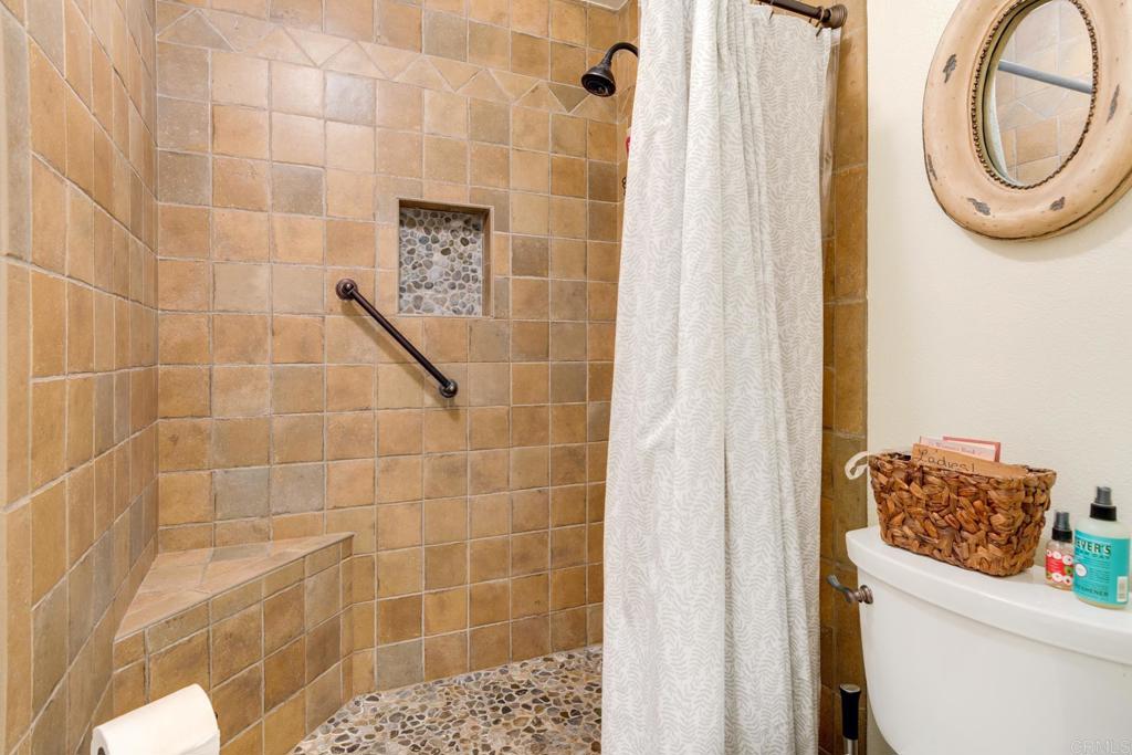 1106 Big Oak Ranch Road Fallbrook, CA 92028 - Photo 28 of 53 a bathroom with a toilet and a shower curtain