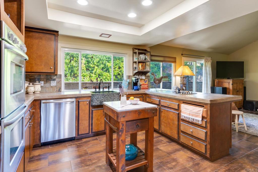 1106 Big Oak Ranch Road Fallbrook, CA 92028 - Photo 3 of 53 a kitchen with a sink stove and cabinets