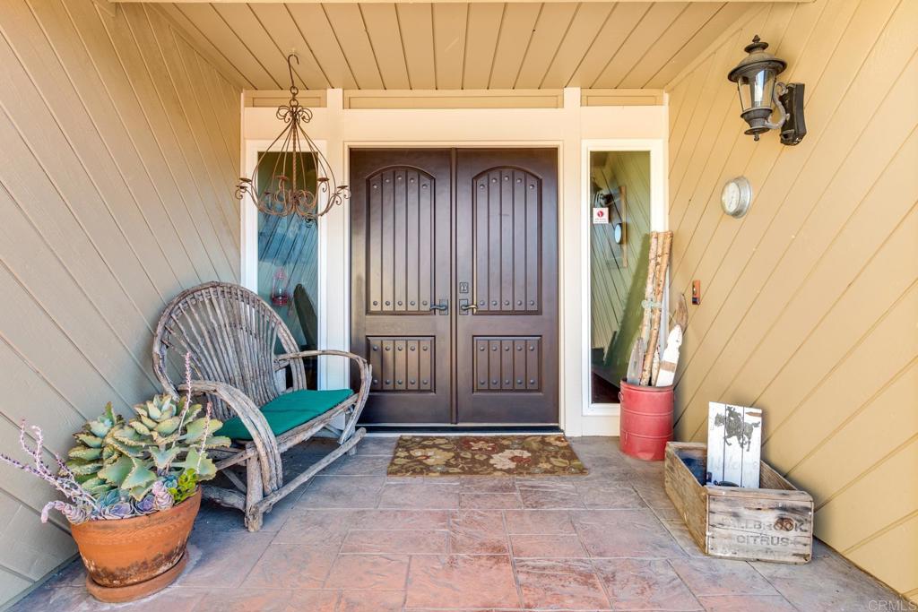 1106 Big Oak Ranch Road Fallbrook, CA 92028 - Photo 39 of 53 a front view of a house with outdoor seating and a potted plant