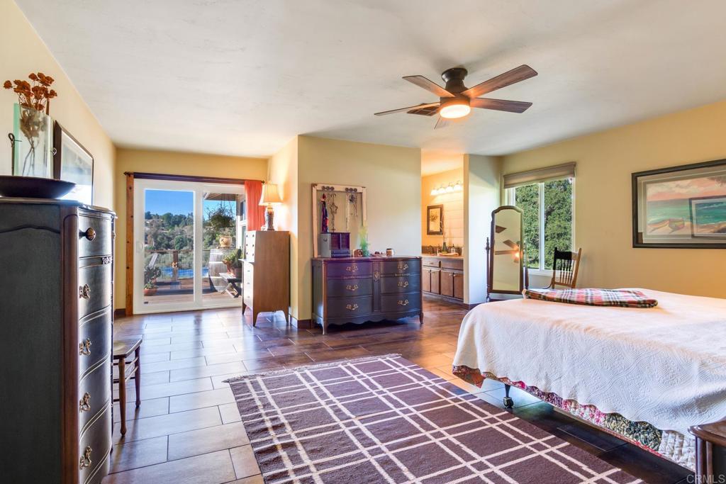 1106 Big Oak Ranch Road Fallbrook, CA 92028 - Photo 8 of 53 a bedroom with a bed and glass door