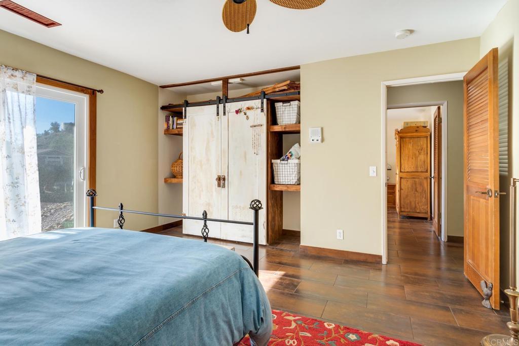 1106 Big Oak Ranch Road Fallbrook, CA 92028 - Photo 9 of 53 a bedroom with a bed and a mirror