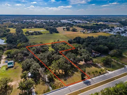 an aerial view of a residential houses with outdoor space and swimming pool