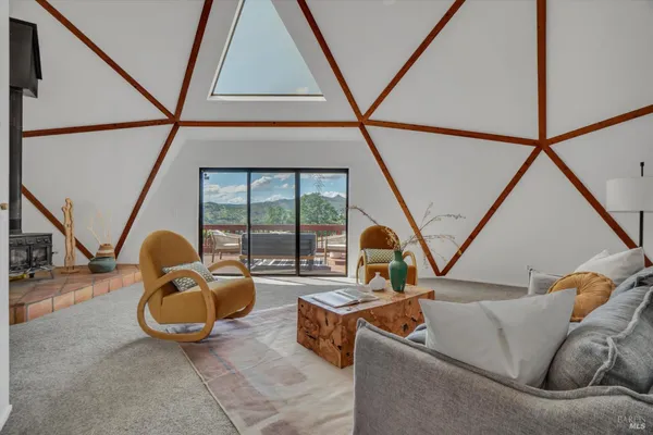 a living room with furniture and a floor to ceiling window
