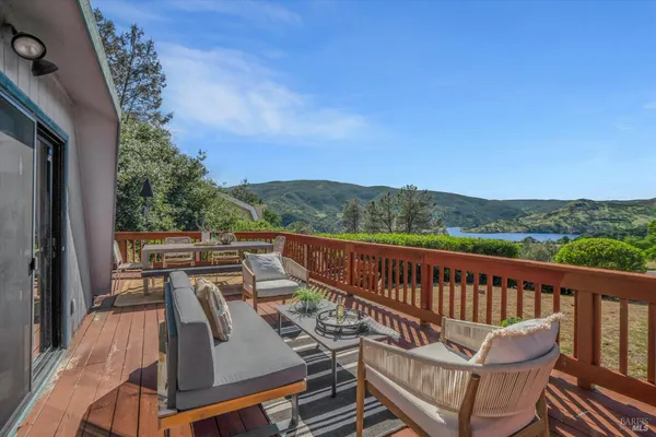 a view of a chairs and table on the balcony