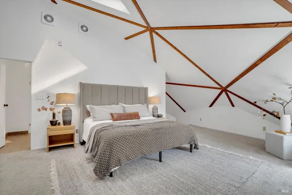 a bedroom with a bed and lamp