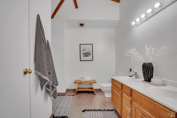 a hallway with a sink and a mirror