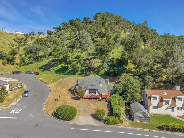 an aerial view of a house with yard and street view