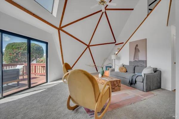 a living room with furniture a fireplace and next to a window