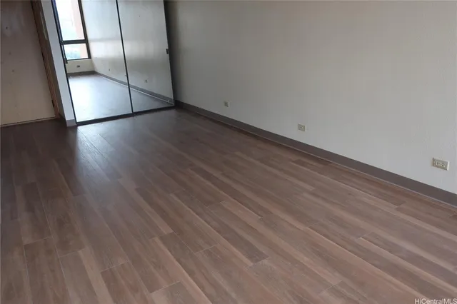 a view of an empty room and wooden floor