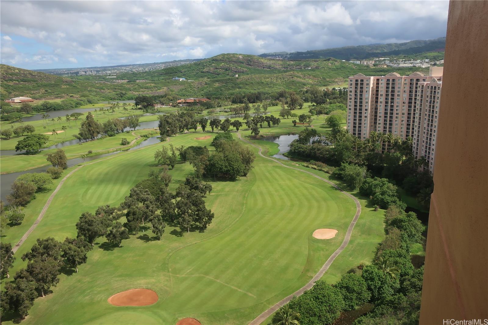 5333 Likini Street, Unit 2408 Honolulu, HI 96818 - Photo 18 of 20 a view of a garden with a building in the background