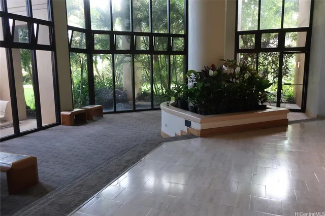 a living room with furniture and a floor to ceiling window