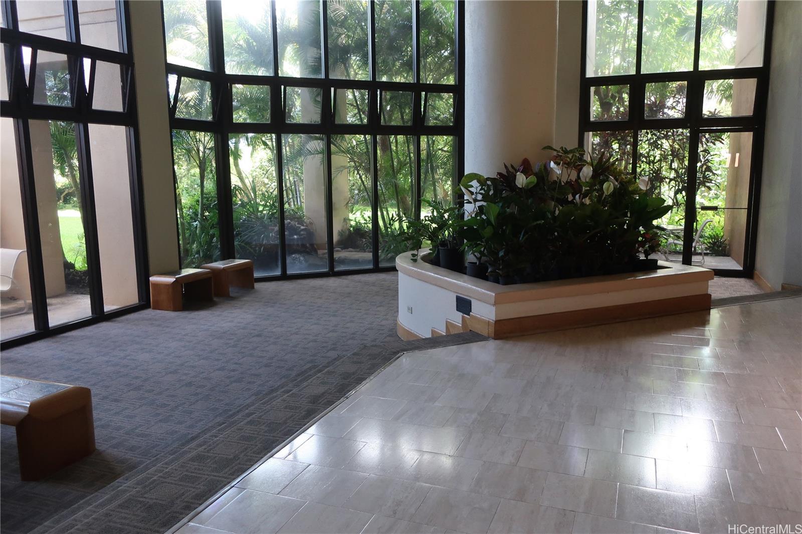 5333 Likini Street, Unit 2408 Honolulu, HI 96818 - Photo 6 of 20 a living room with furniture and a floor to ceiling window