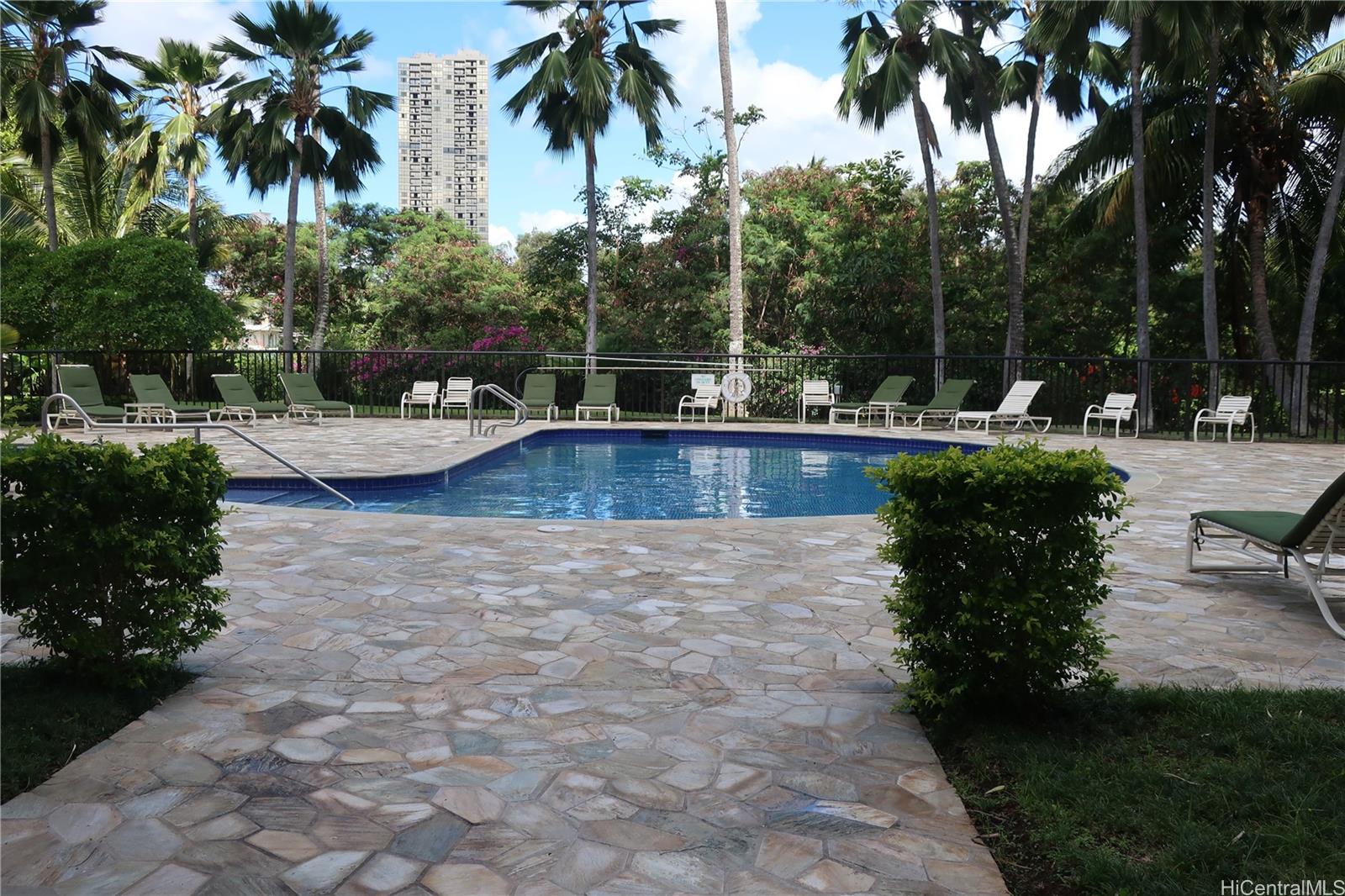 5333 Likini Street, Unit 2408 Honolulu, HI 96818 - Photo 8 of 20 a view of a swimming pool with a patio and a garden