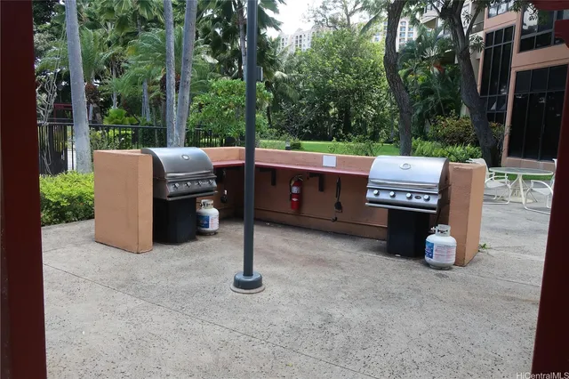 a view of a chairs and tables in the back yard of the house