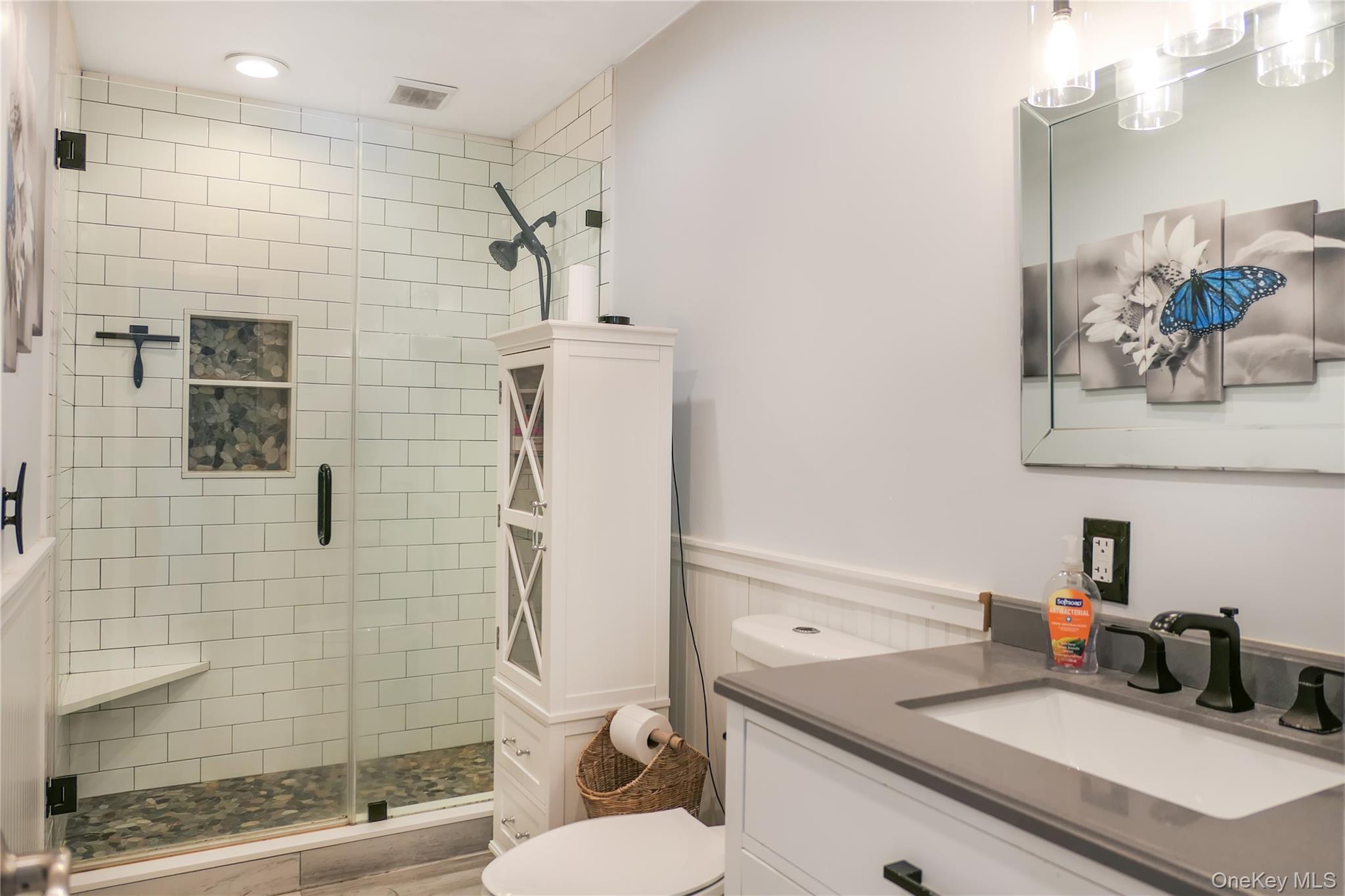 84 Bieselin Road Bellport, NY 11713 - Photo 11 of 20 a bathroom with a sink a toilet and shower