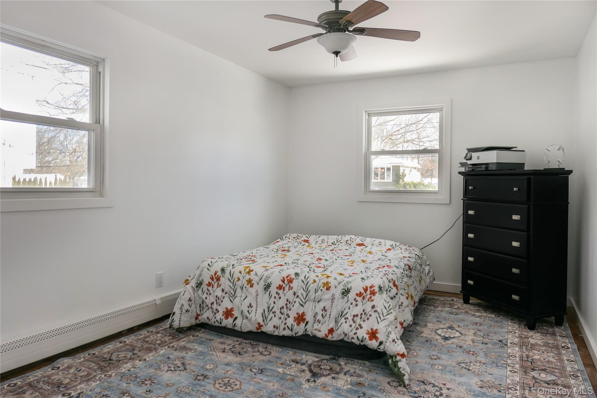 84 Bieselin Road Bellport, NY 11713 - Photo 14 of 20 a bedroom with a bed and a window