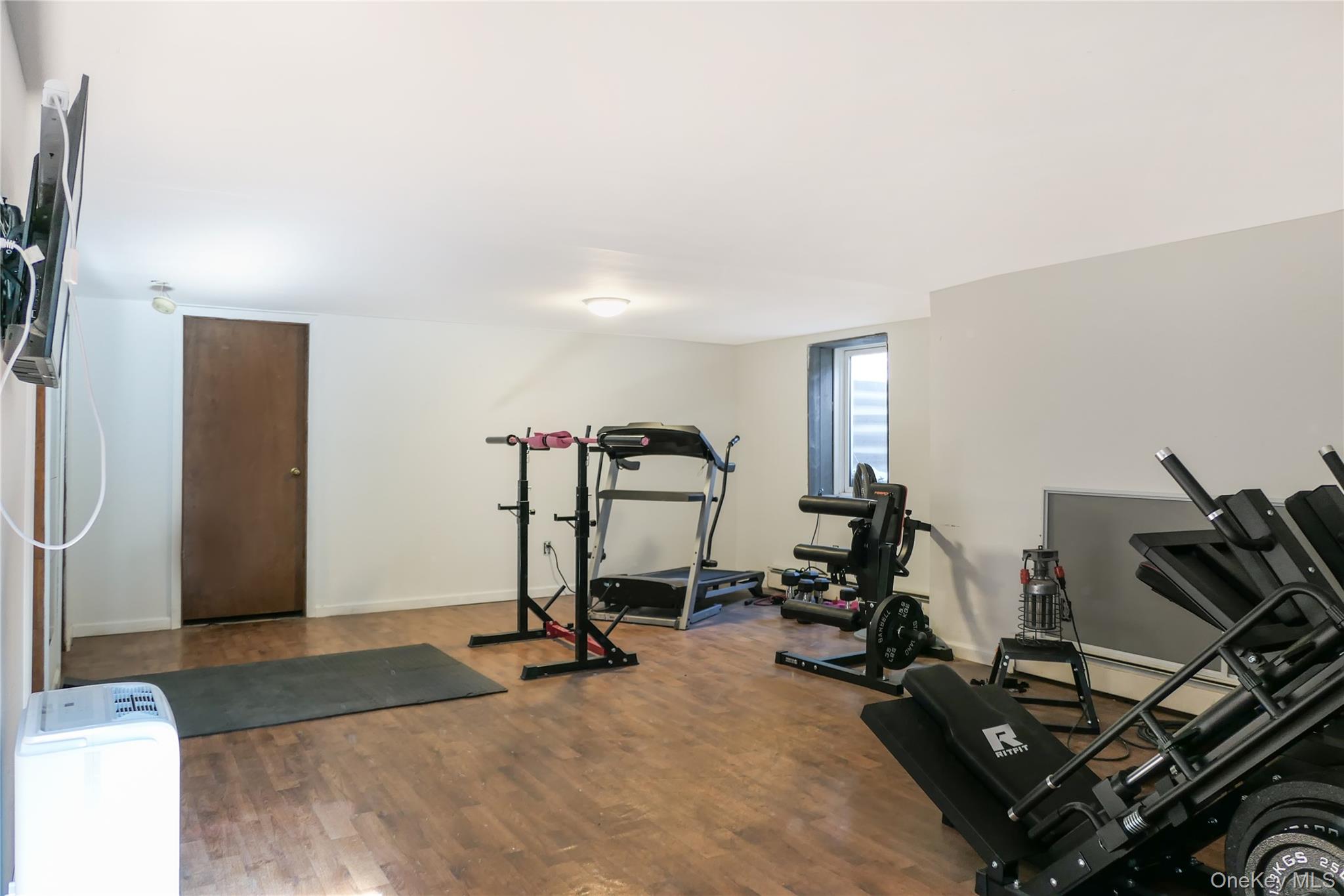 84 Bieselin Road Bellport, NY 11713 - Photo 15 of 20 a view of a room with gym equipment