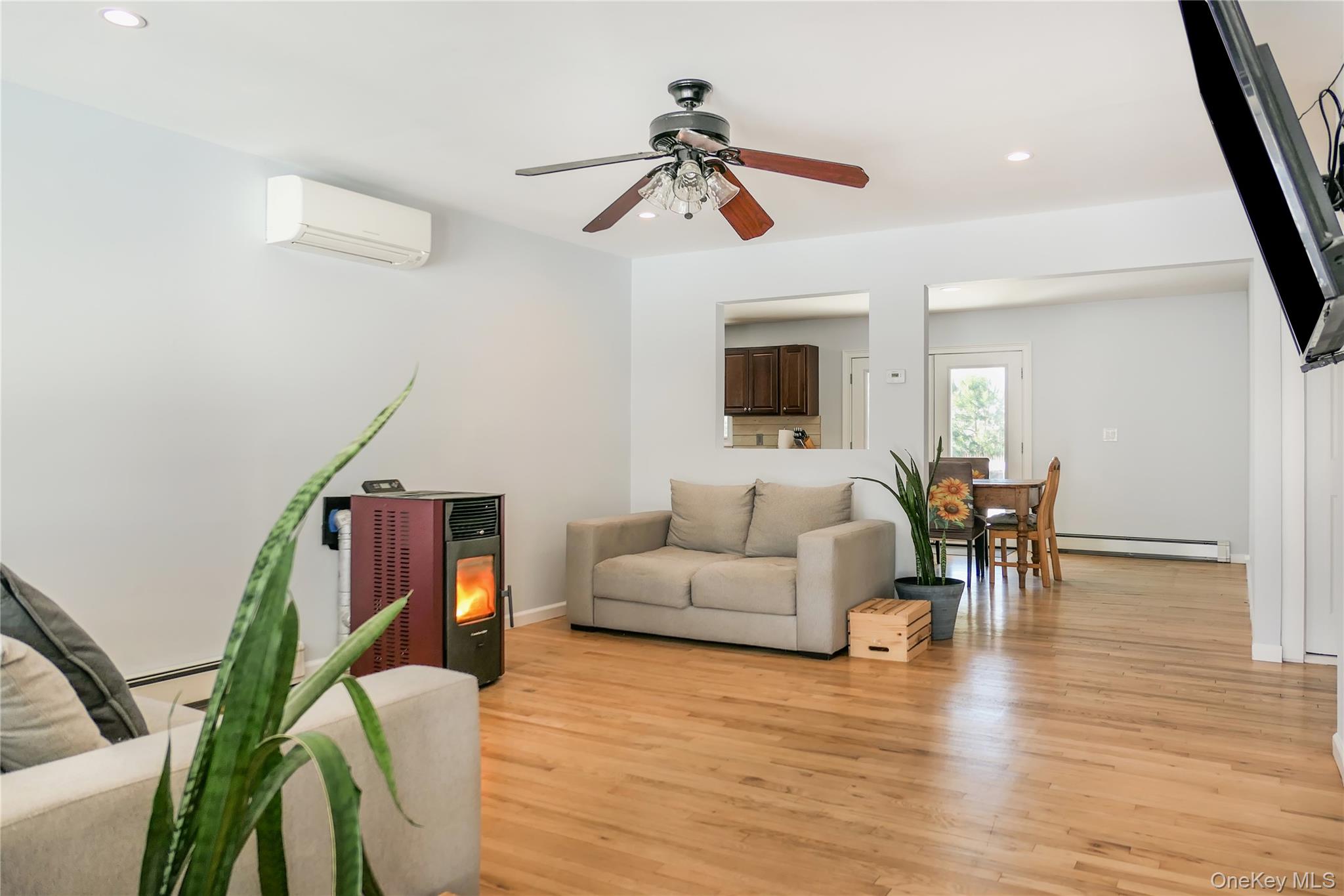 84 Bieselin Road Bellport, NY 11713 - Photo 2 of 20 a living room with furniture and a wooden floor