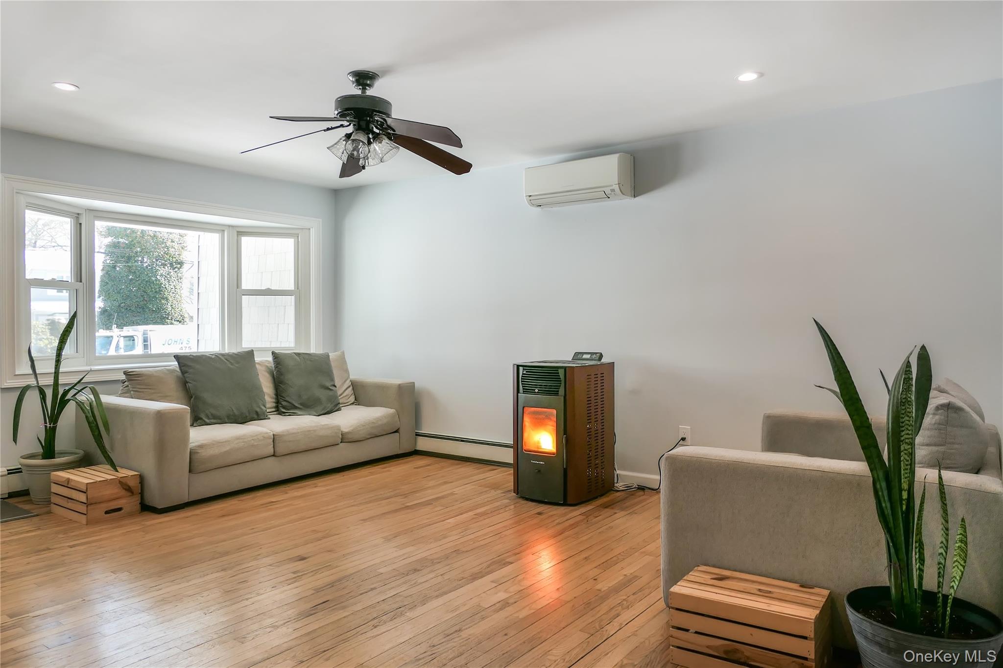 84 Bieselin Road Bellport, NY 11713 - Photo 3 of 20 a living room with furniture and a potted plant