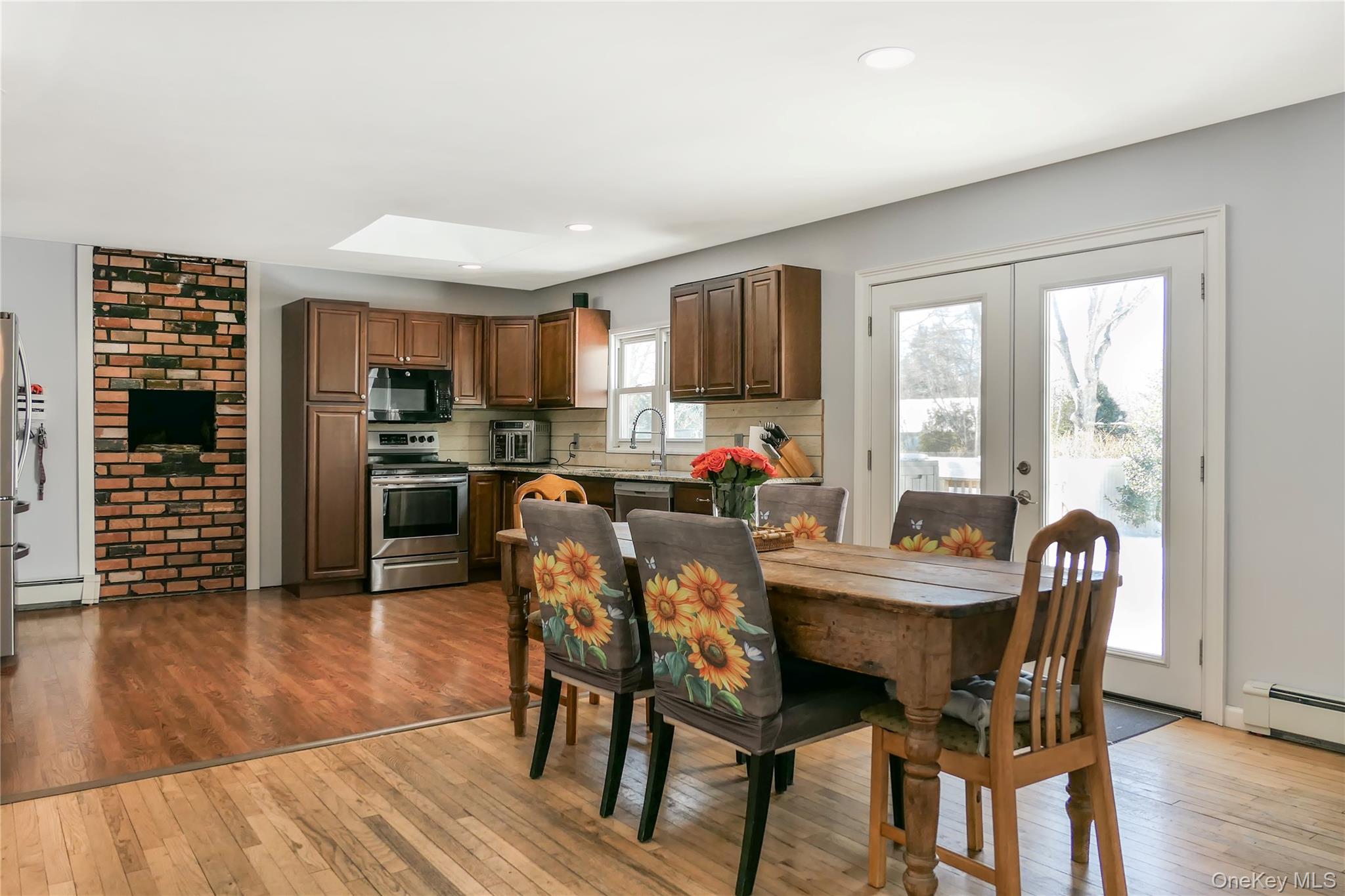 84 Bieselin Road Bellport, NY 11713 - Photo 4 of 20 a view of a dining room with furniture window and wooden floor