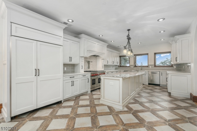 50 Rock Spring Road West Orange, NJ 07052 - Photo 16 of 37 a kitchen with white cabinets and appliances