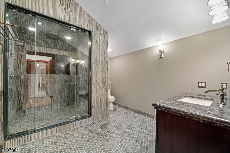 50 Rock Spring Road West Orange, NJ 07052 - Photo 29 of 37 a bathroom with a granite countertop sink a mirror and shower