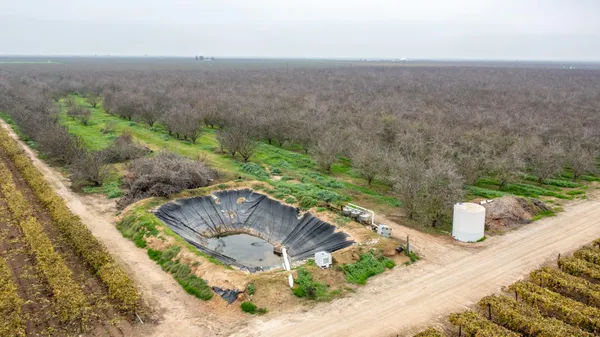 an aerial view of a house with a yard and lake view