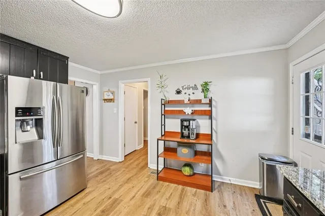 a kitchen with granite countertop stainless steel appliances and wooden cabinets