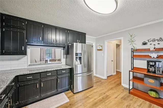 a kitchen with stainless steel appliances granite countertop a sink stove and cabinets