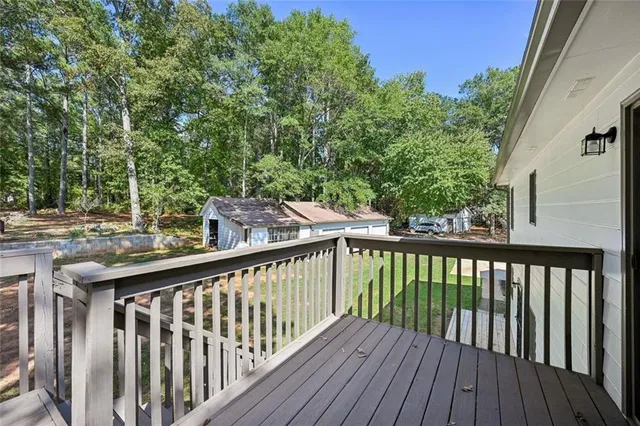 a view of a house with backyard and a tree
