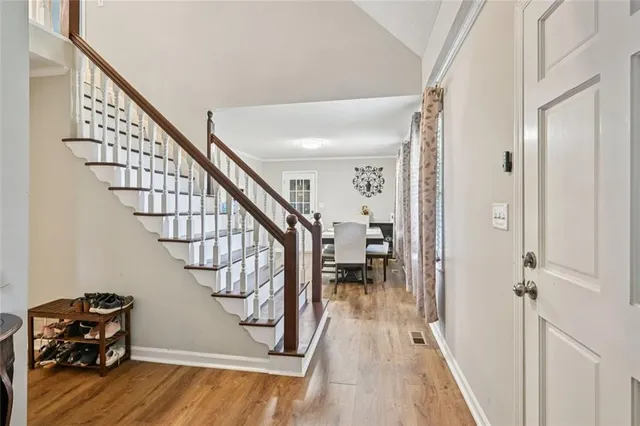 a view of entryway and hall with wooden floor